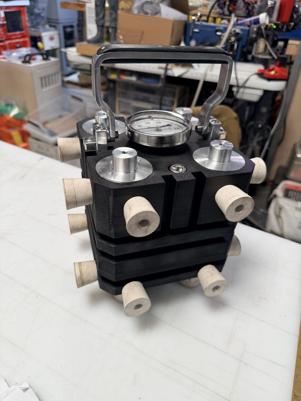 Figure 19 — The black-crackle finish at completion. The wrinkle/texture of the PJ1 paint is visible across all surfaces; the silver-painted aluminum hardware contrasts cleanly against the black body. Bumpers a…