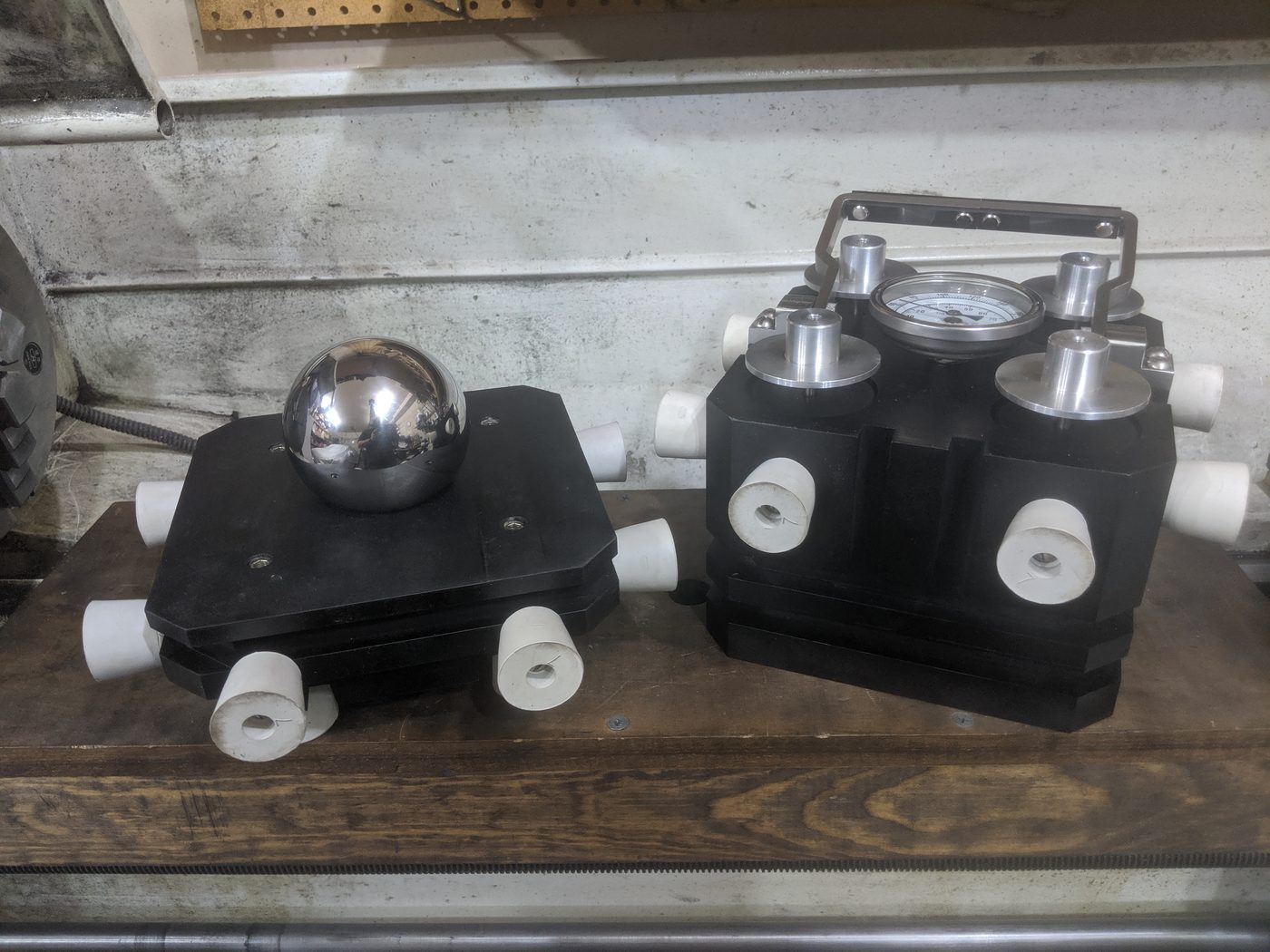 Figure 1 — The visual target. Adam Savage's Tested demon-core replica shown twice — open at left with the polished tungsten-alloy sphere seated in its cradle, closed at right with the full hardware suite (the…
